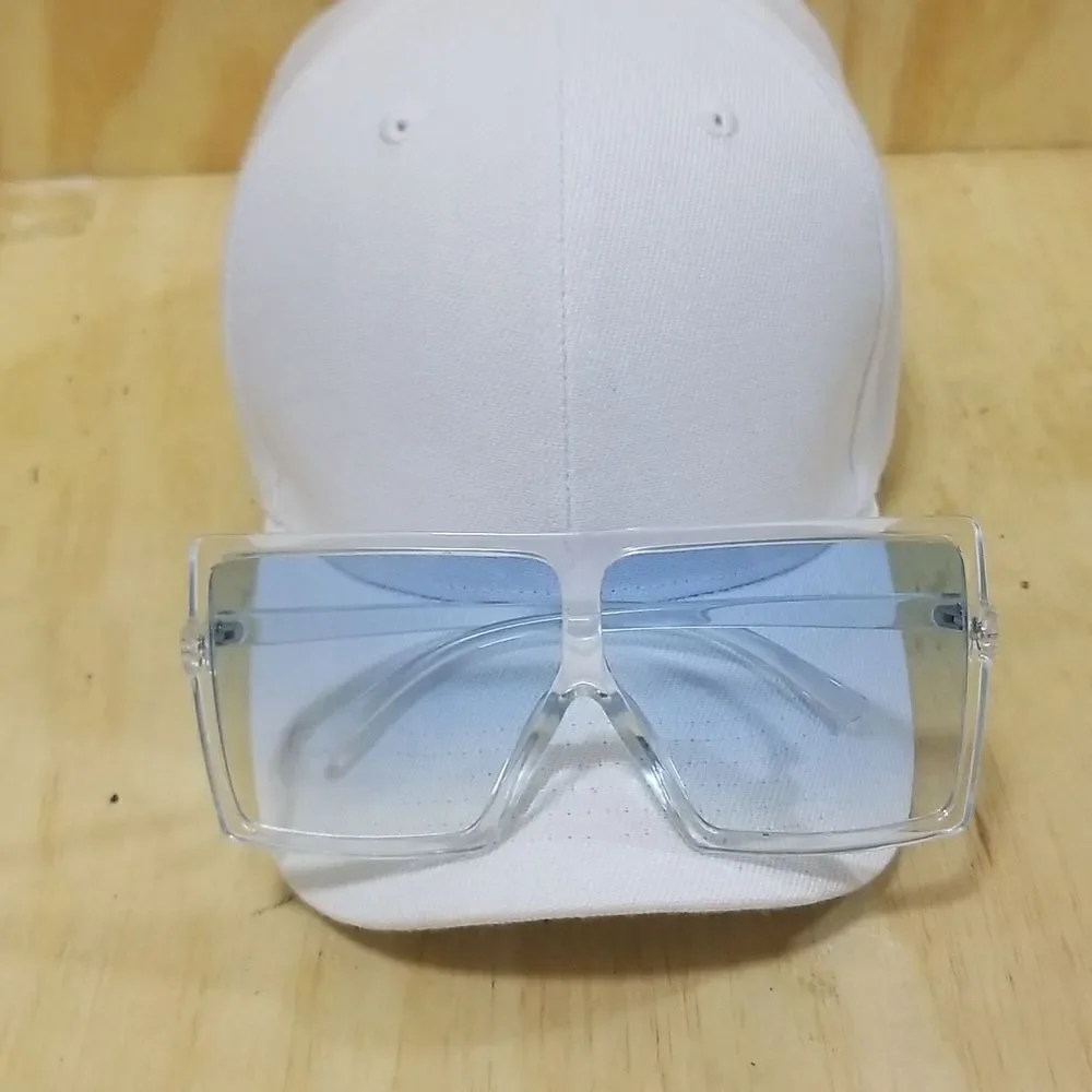 High Fashion Women's Sunglasses with clear frames/ blue tented lenses.